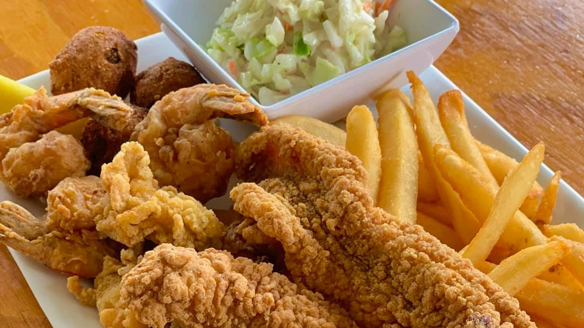 Southern fried seafood platter with fish, shrimp, hush puppies, fries and coleslaw.
