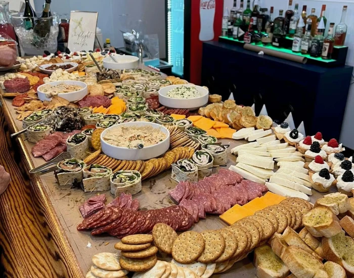 Catering grazing table of charcuterie, cheeses, dips and desserts at Cargo TX