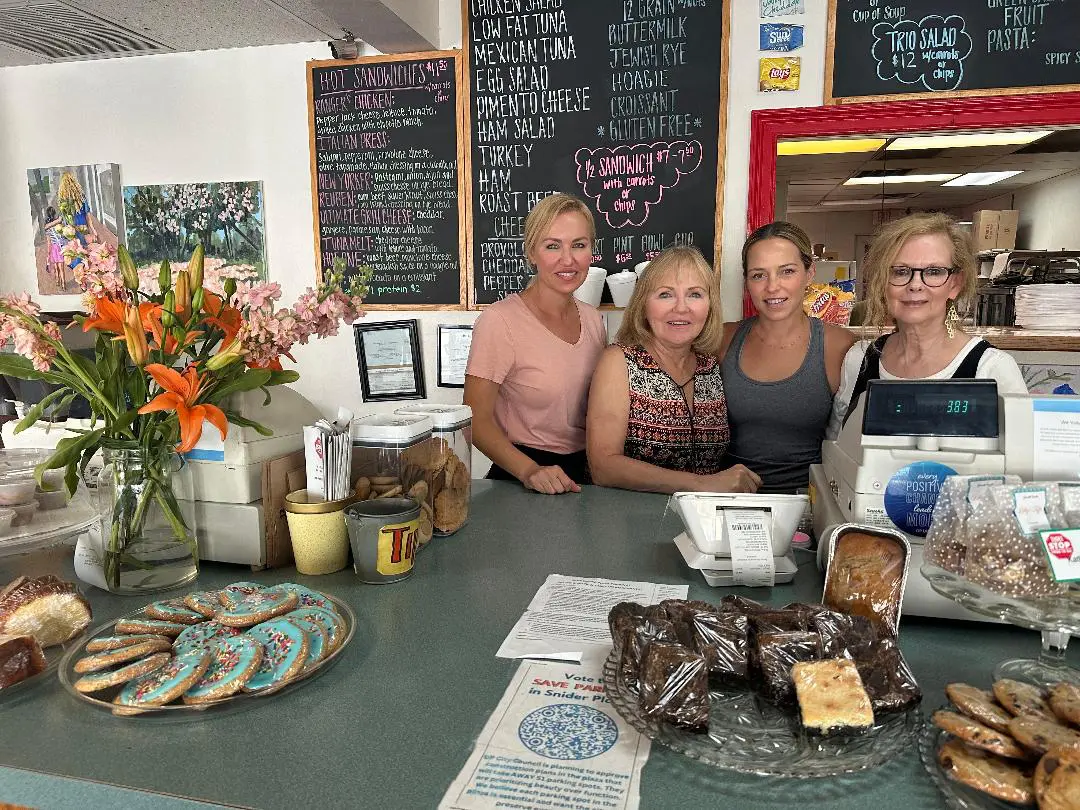 a group photo behind the counter at short stop food to go