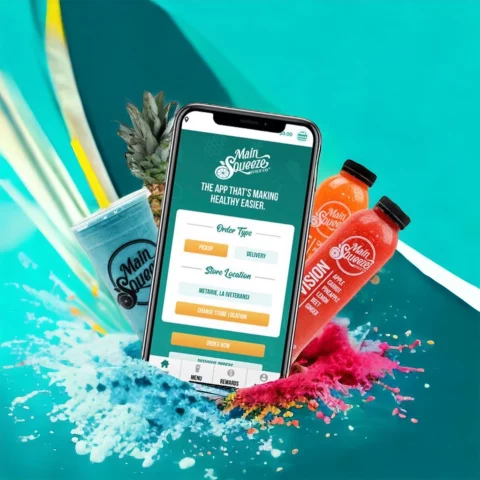 Main Squeeze mobile app promotional image with phone displaying the app interface, surrounded by juice bottles, smoothie, fruit, and colorful powder splash