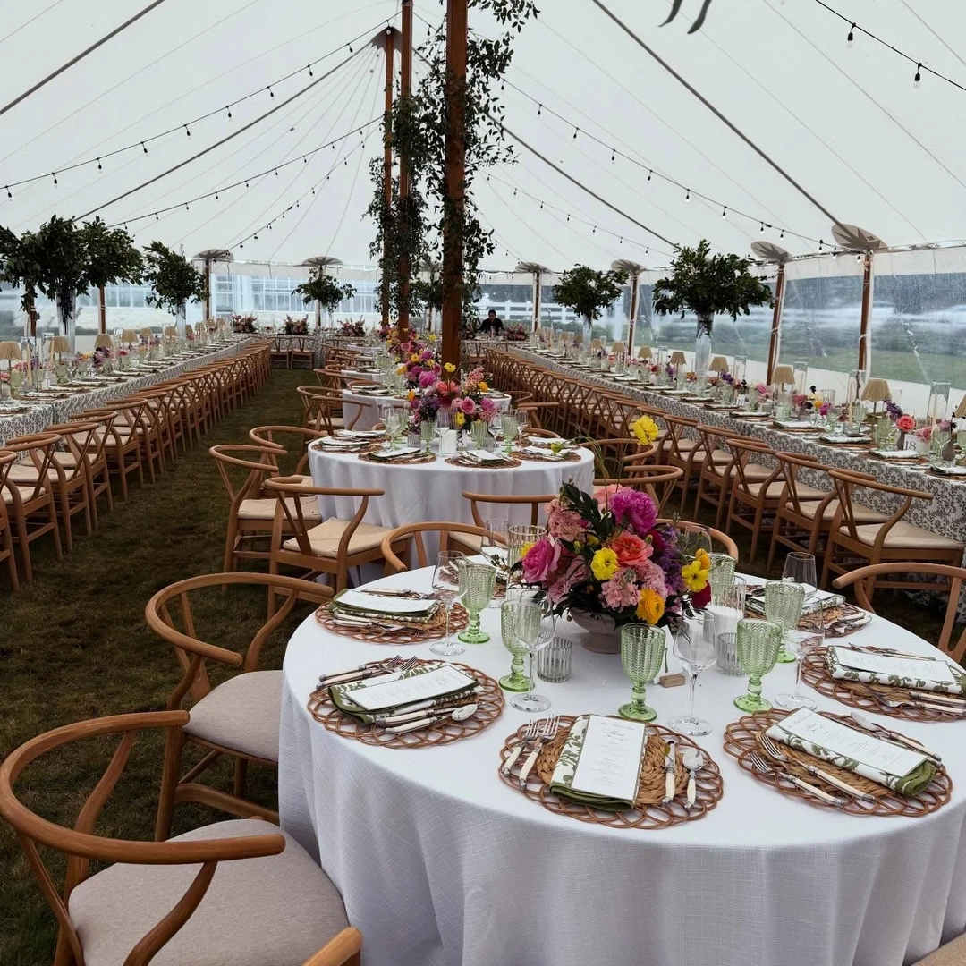 Reception tables set under a tent for a wedding
