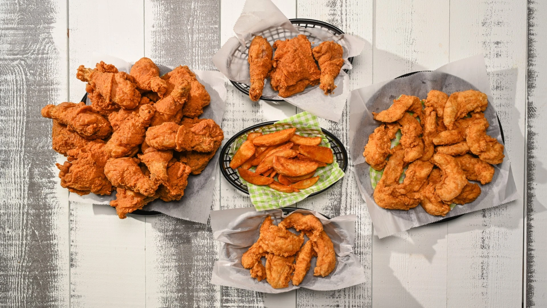 Close-up of crispy fried chicken pieces in paper trays at Chicken Xpress