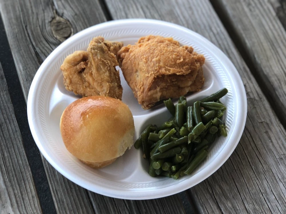 Fried chicken dinner with a yeast roll and green beans at Chicken Country