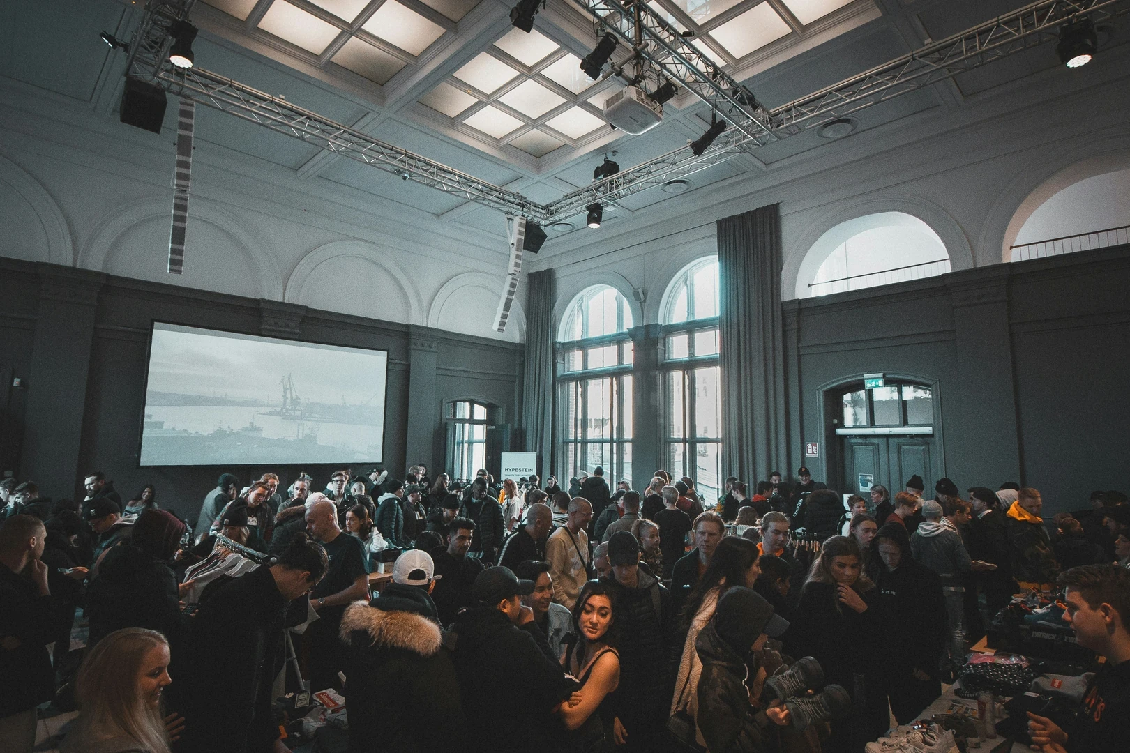 Attendees gathered in a large hall for a presentation