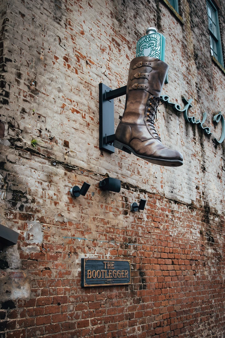 Vintage boot mounted on the brick wall outside The Bootlegger Speakeasy
