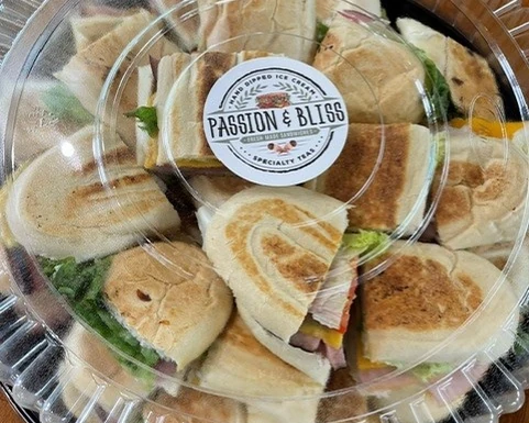 Assorted sandwich catering tray in a clear serving container