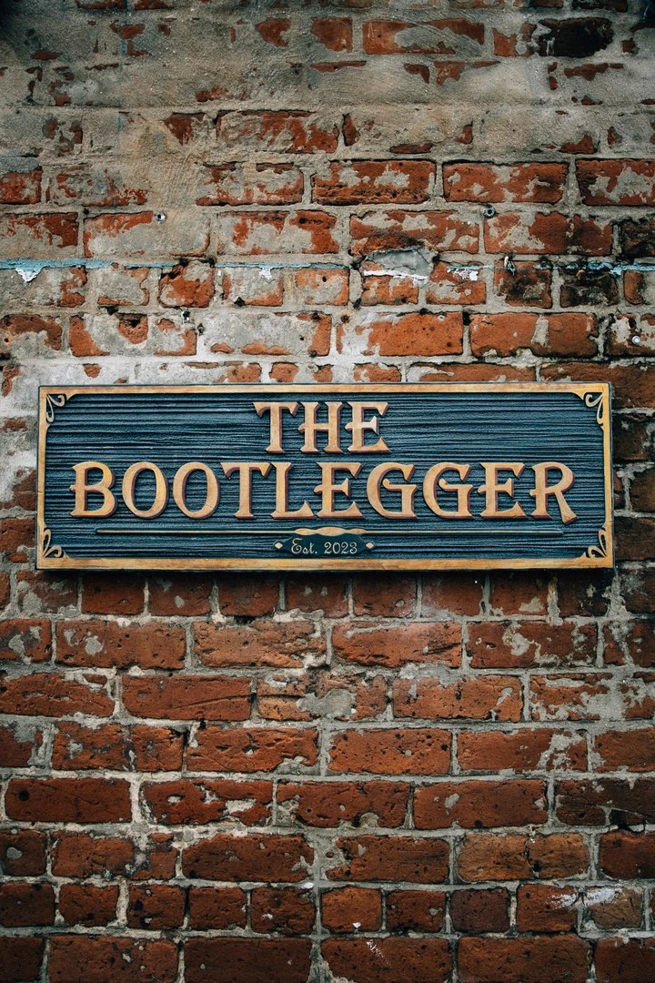 The Bootlegger sign mounted on the historic brick of River Street