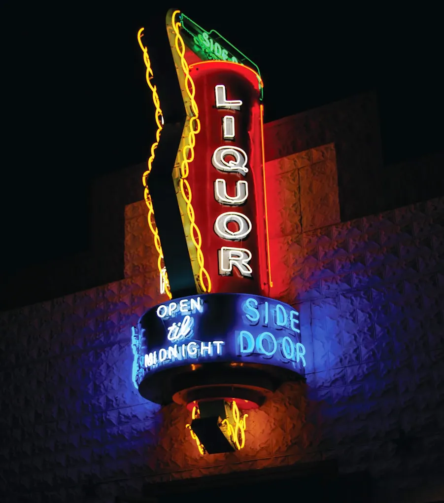 The Side Door Liquor Store neon sign lit at night in El Paso, Texas