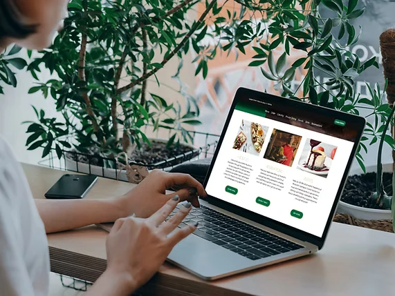 Laptop displaying a restaurant website homepage
